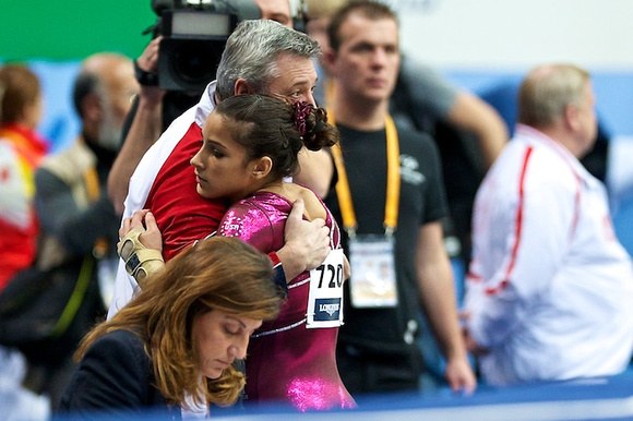 Aly Raisman gets a hug from her coach,Mihai Brestyan