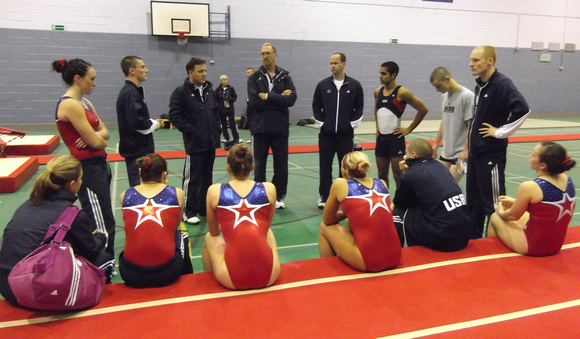 The trampoline team gets instruction from their coaches