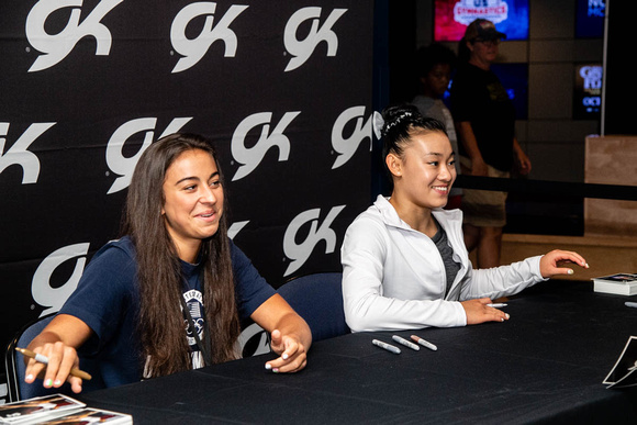 Leanne Wong and Addison Fatta sign autographs before the competition.